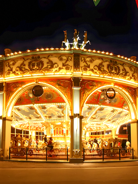 Illuminated carousel at night in Everland theme park, South Korea.