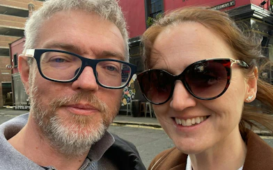 Couple exploring Belfast street during self-guided detective mystery game.