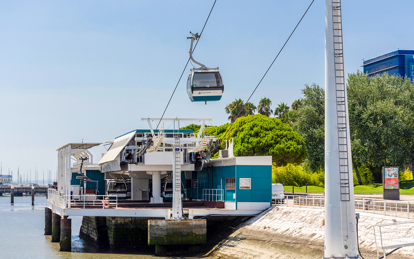 Telecabine Lisbon cable car station by the waterfront with gondola in the air.