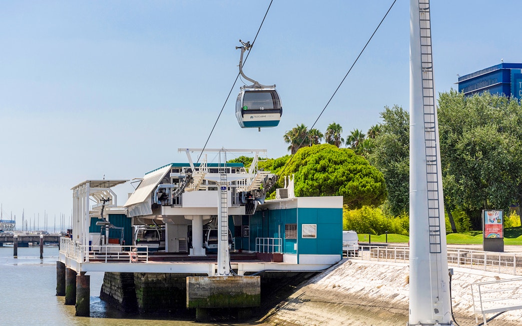 Telecabine Lisbon cable car station by the waterfront with gondola in the air.
