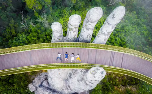 Golden Bridge in Sun World Ba Na Hills, Da Nang, with giant stone hands.