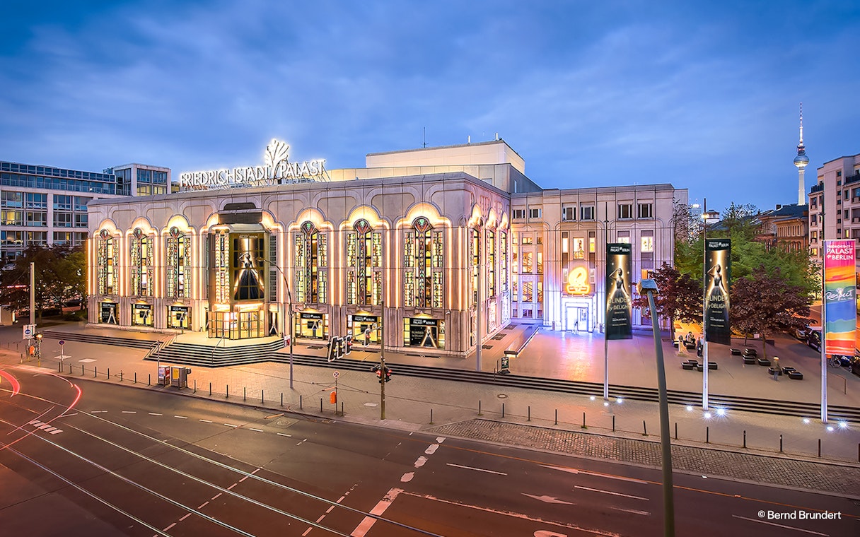 Friedrichstadt Palast exterior illuminated at dusk, Berlin, Germany.