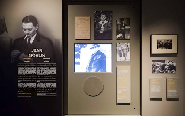 Jean Moulin exhibit at Liberation Museum, Paris, featuring historical photos and documents.