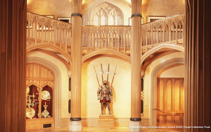 Windsor Castle interior with ornate wooden columns and medieval armor display.