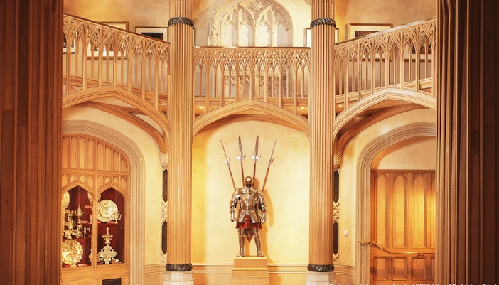 Windsor Castle interior with ornate wooden columns and medieval armor display.