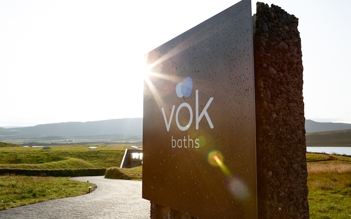 Vök Baths entrance sign with scenic view in Egilsstaðir, Iceland.