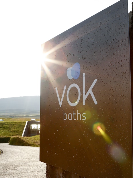 Vök Baths entrance sign with scenic view in Egilsstaðir, Iceland.