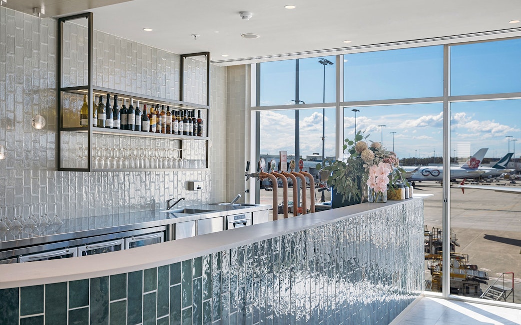 Bar area at Plaza Premium Lounge with airport view, International Arrival.
