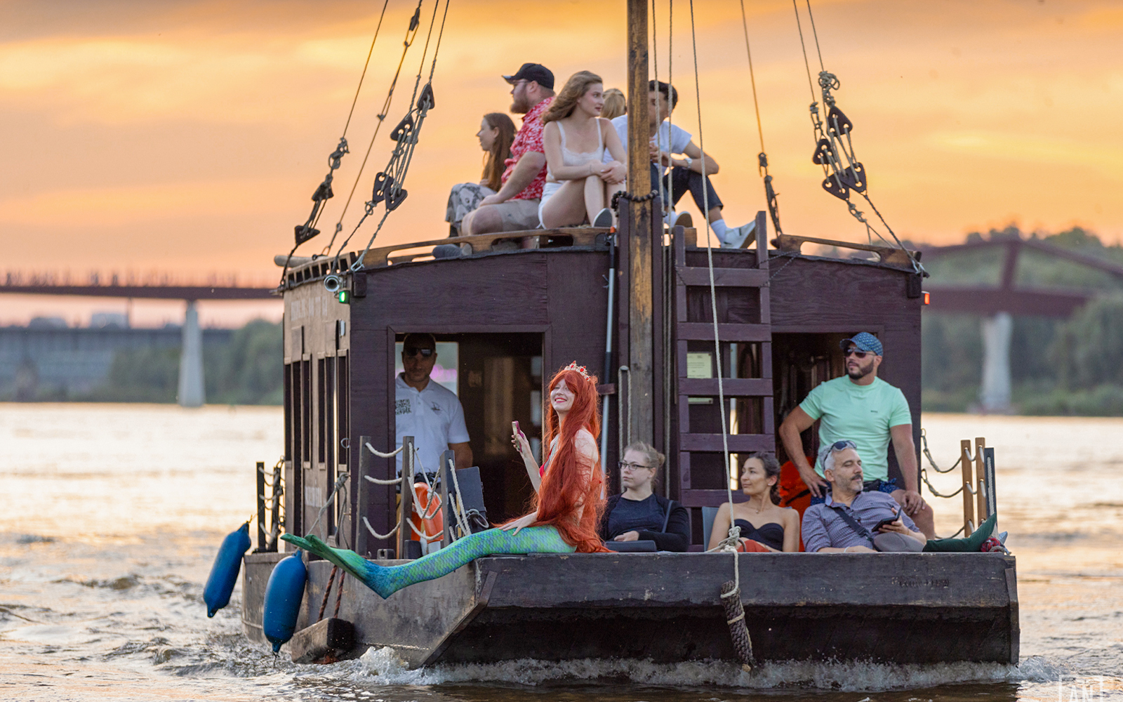 Traditional Galar cruise on Vistula River with mermaid and passengers at sunset.