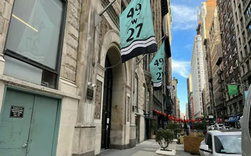 Street view of 49 W 27th St in New York, featuring historic architecture and city exploration route.