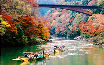Boat tour on Hozugawa River with autumn foliage, Arashiyama, Kyoto.