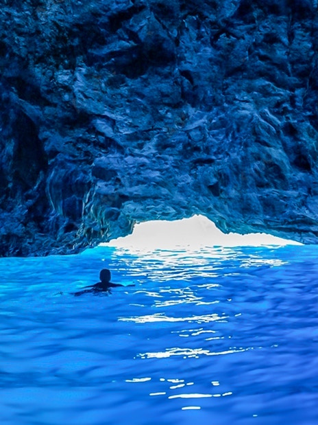 Swimming in the vibrant waters of a blue cave.