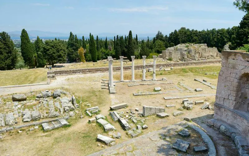 Ancient ruins of Asclepieion at Kos with columns and stone remnants, Rhodes.