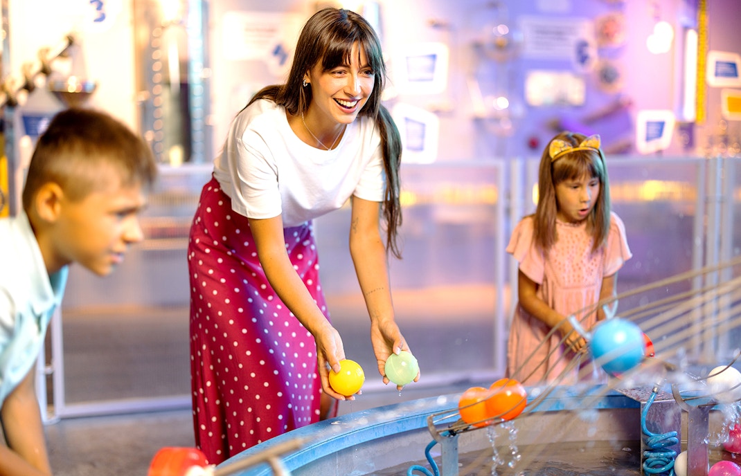 Belfast science and discovery center with Hop On Hop Off tour bus in foreground.