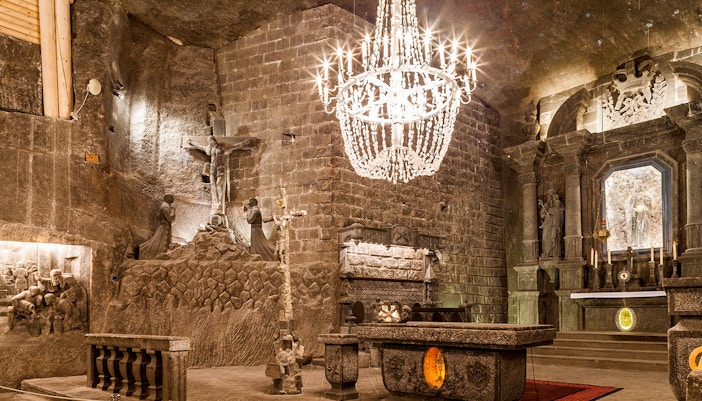 Wieliczka Salt Mine chapel with salt carvings and chandelier, part of Krakow tour.