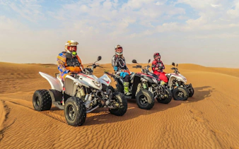 Quad biking adventure in Dubai desert with riders on sand dunes.