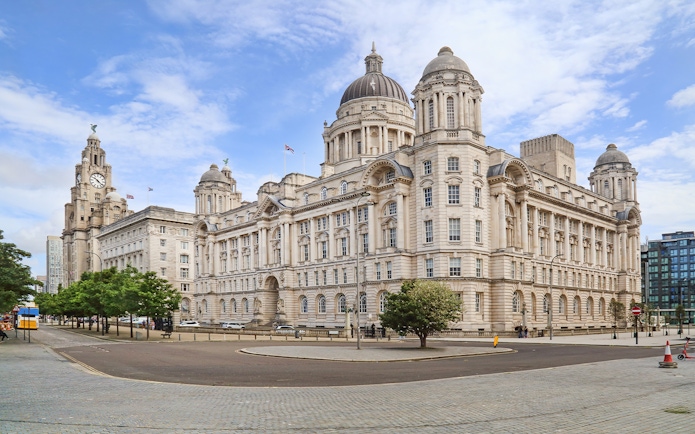 Port of Liverpool Building with hop on hop off bus nearby.
