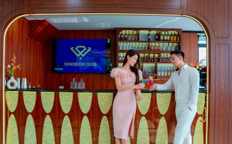 Couple enjoying drinks at the bar on Ha Long Bay's Diamond Era Luxury Day Cruise.