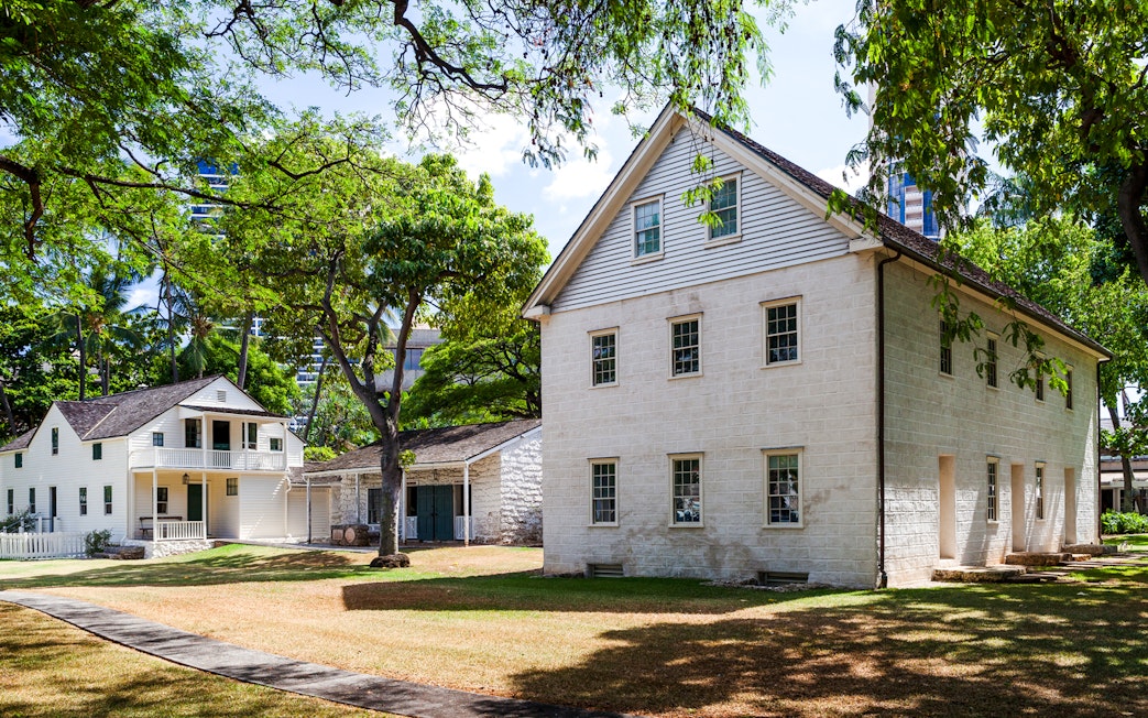 Hawaiian Mission Houses Historic Site in Honolulu with traditional architecture and lush greenery.