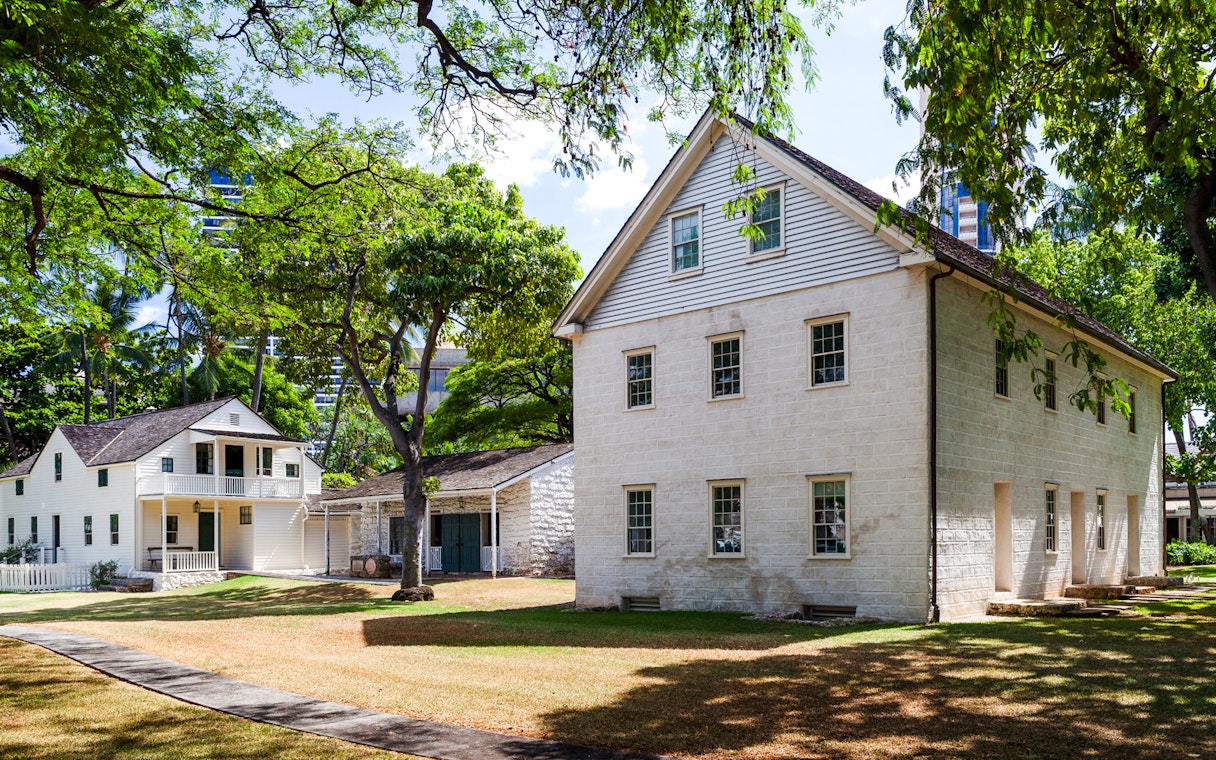 Hawaiian Mission Houses Historic Site in Honolulu with traditional architecture and lush greenery.