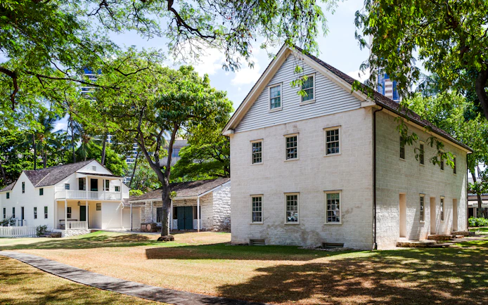 Hawaiian Mission Houses Historic Site in Honolulu with traditional architecture and lush greenery.