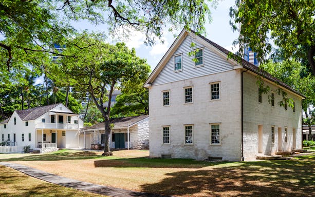 Hawaiian Mission Houses Historic Site in Honolulu with traditional architecture and lush greenery.