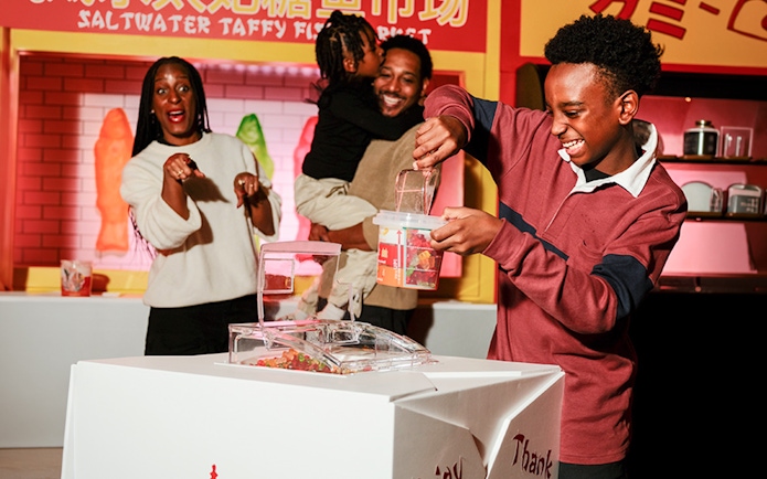 Family enjoying candy selection at iCandy Experience in NYC.