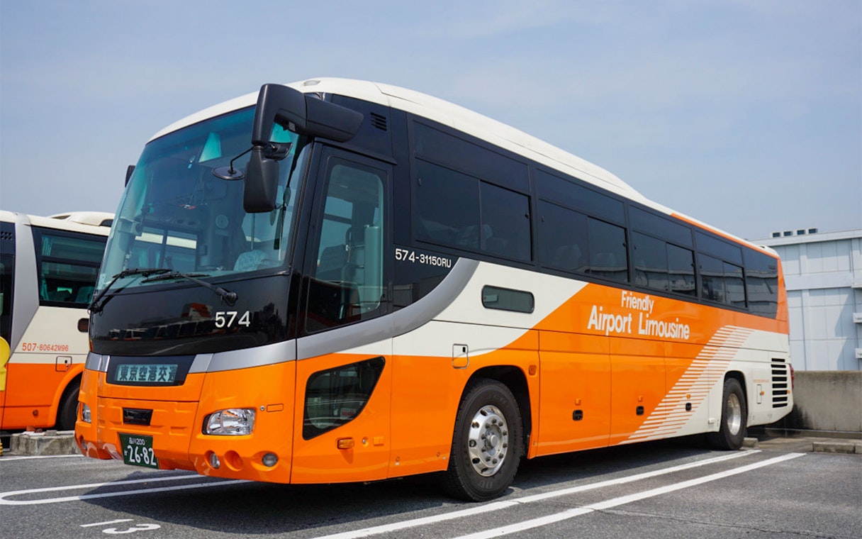 Bus for Narita Airport to Central Tokyo transfer service in parking area.