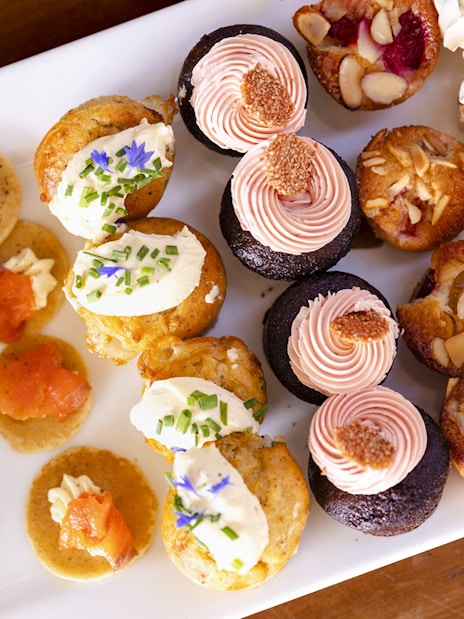 Assorted desserts and sandwiches on a platter for onboard dining experience.