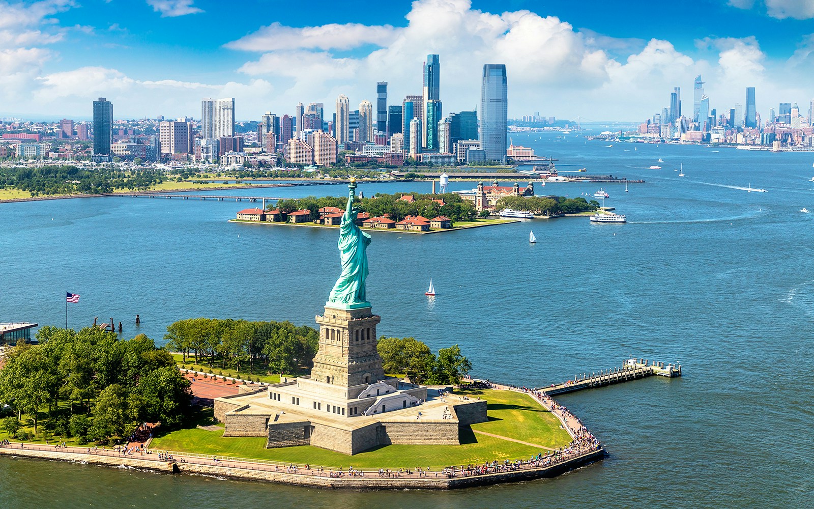Statue of Liberty on Liberty Island with New York City skyline in the background.