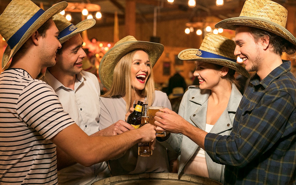 People toasting with drinks at Australian Outback Spectacular Heartland Show.