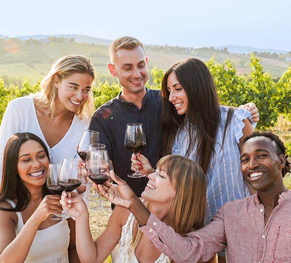 Group enjoying wine and snacks in a vineyard during a Provence day trip.