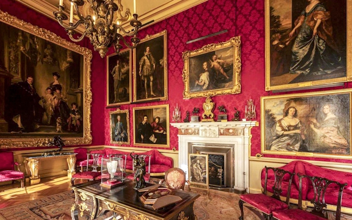 Blenheim Palace State Room with ornate paintings and luxurious red decor.