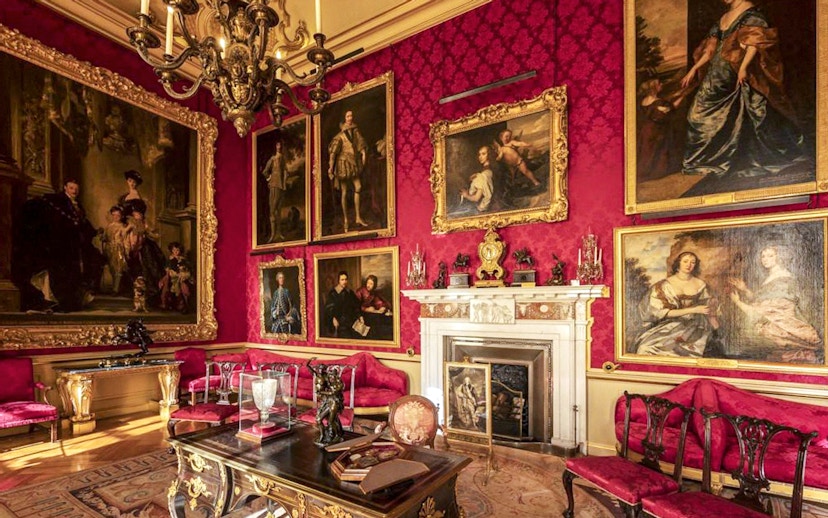 Blenheim Palace State Room with ornate paintings and luxurious red decor.