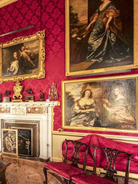 Blenheim Palace State Room with ornate paintings and luxurious red decor.