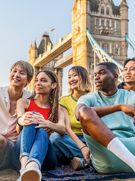 Tourists taking a selfie with Tower Bridge in London, showcasing exclusive access with Tower Bridge Tickets.