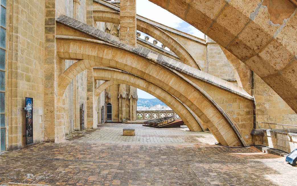 Terrace arches of Cathedral of Majorca with city view in the background.