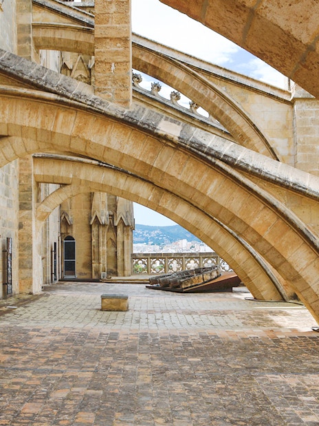 Terrace arches of Cathedral of Majorca with city view in the background.