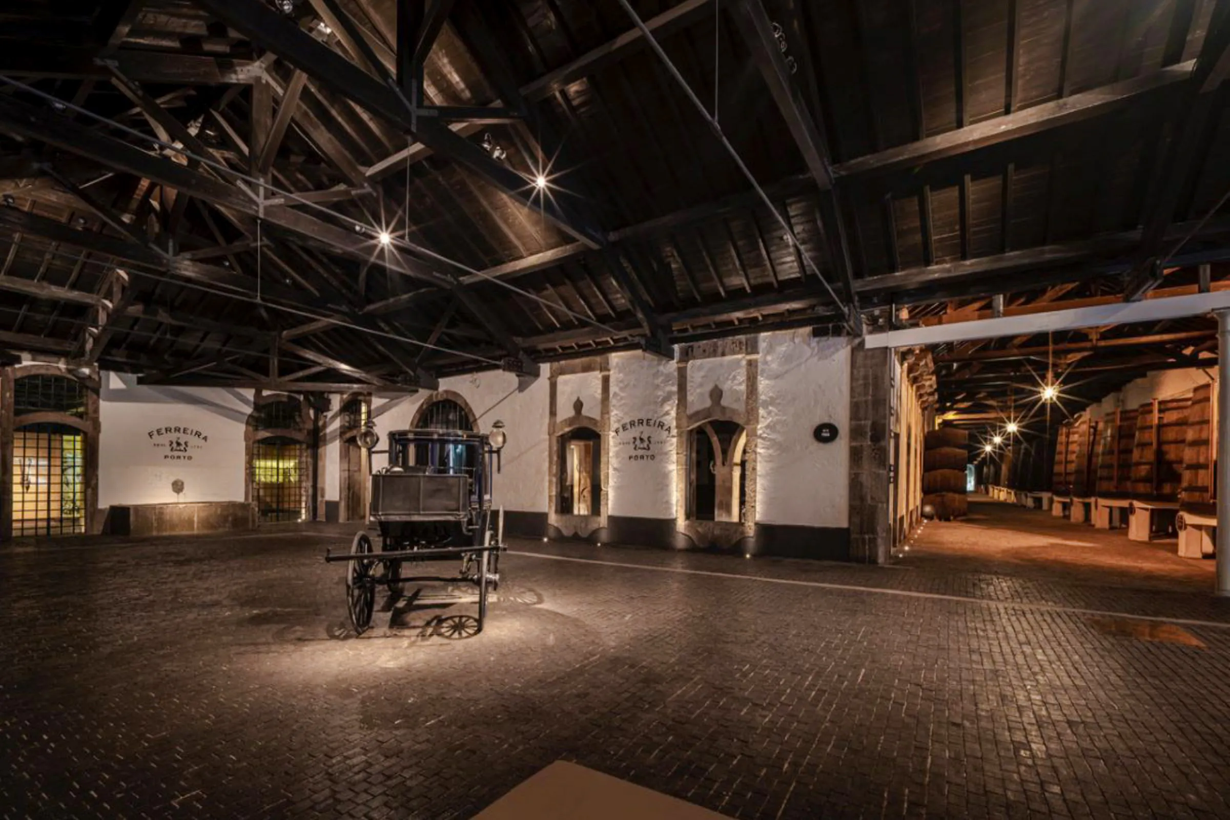 Ferreira Port Wine Cellar interior with barrels and vintage cart, Porto.
