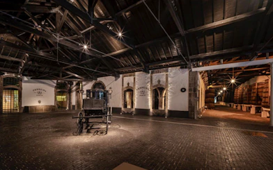 Ferreira Port Wine Cellar interior with barrels and vintage cart, Porto.
