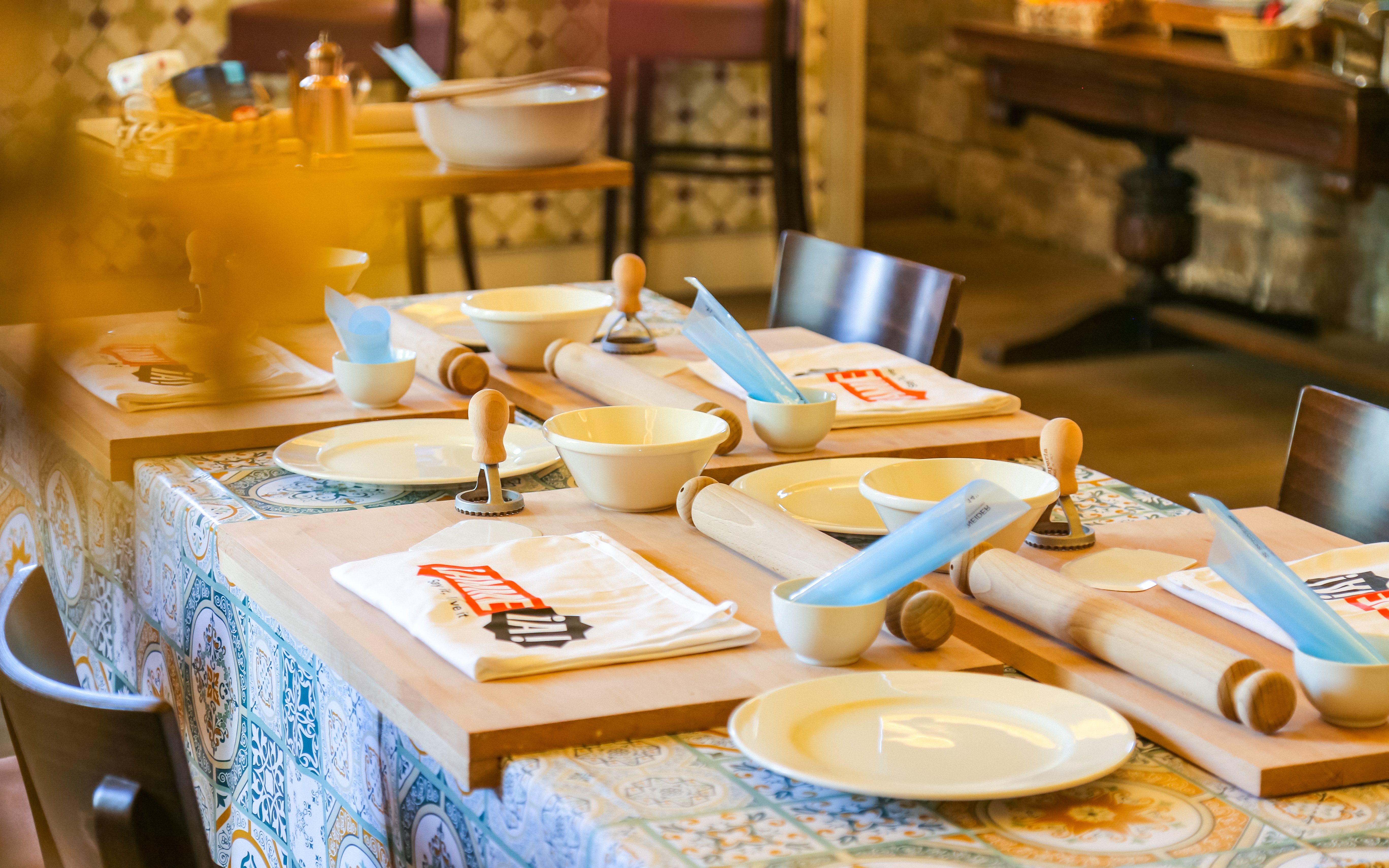 Table setup with rolling pins and bowls at Neapolitan Cooking School in Sorrento.