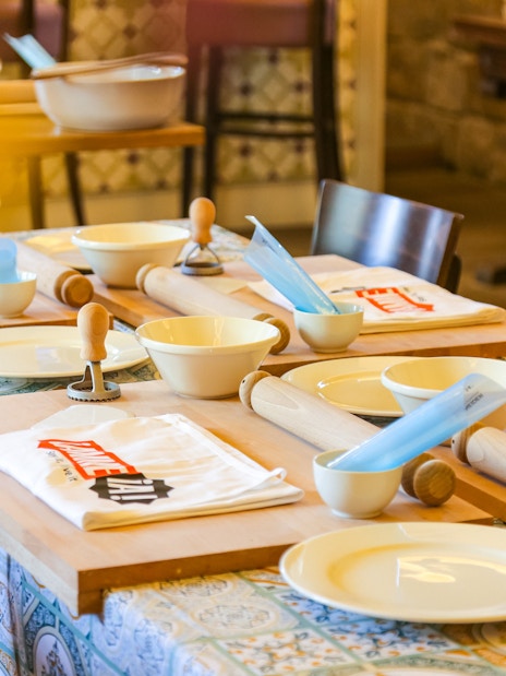 Table setup with rolling pins and bowls at Neapolitan Cooking School in Sorrento.
