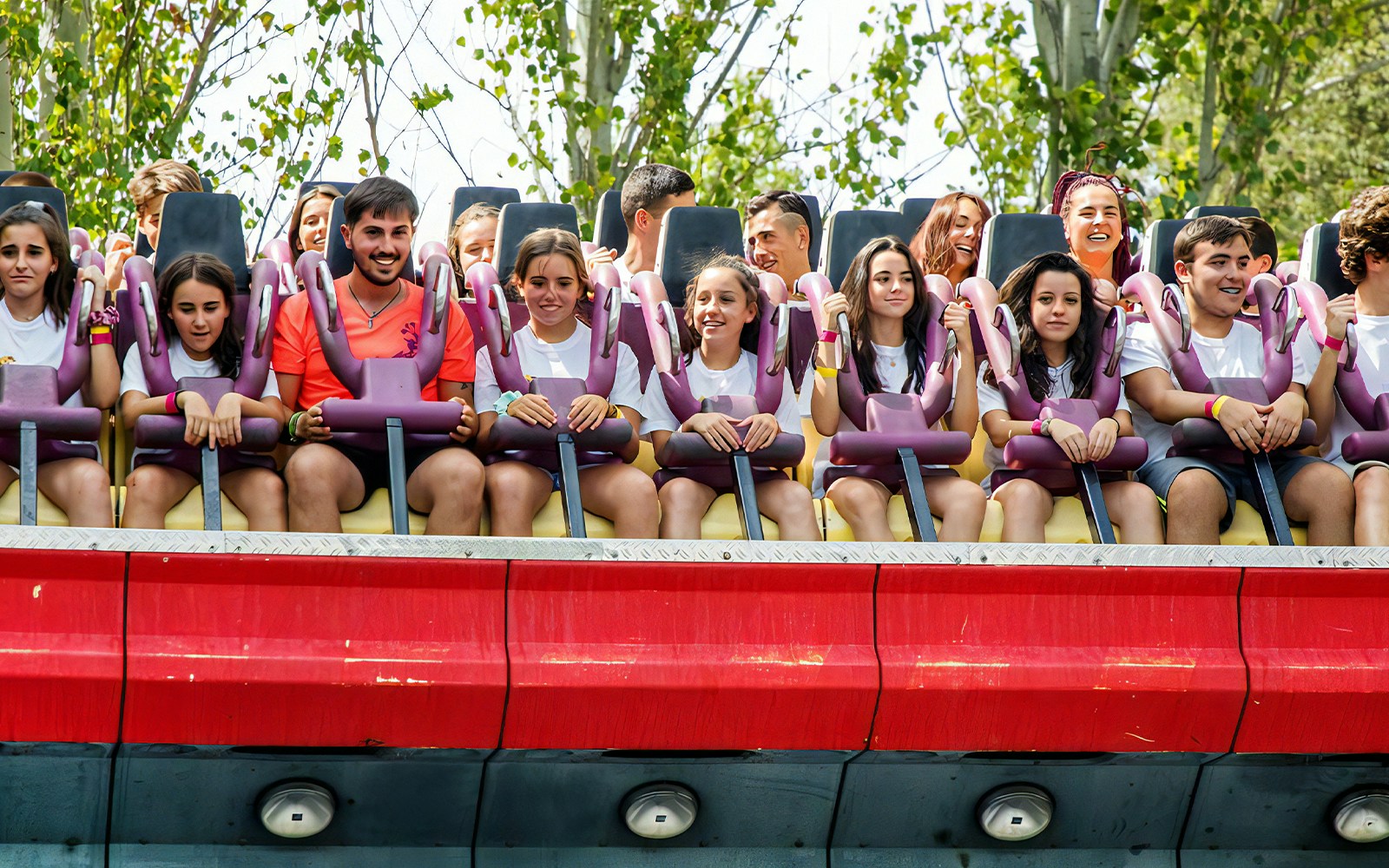 Top Spin ride at Parque De Atracciones with people experiencing thrilling spins and flips.