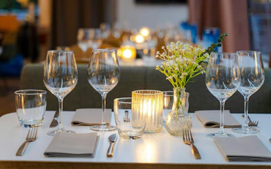 Dinner table setup with wine glasses and candles on a Stavanger dinner cruise.
