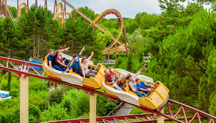 Visitors enjoying the Hydrolix ride at Parc Asterix, France, with vibrant themed surroundings.