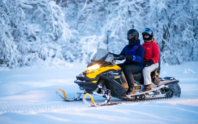 Snowmobile ride through snowy forest on small-group day trip, Tromso.