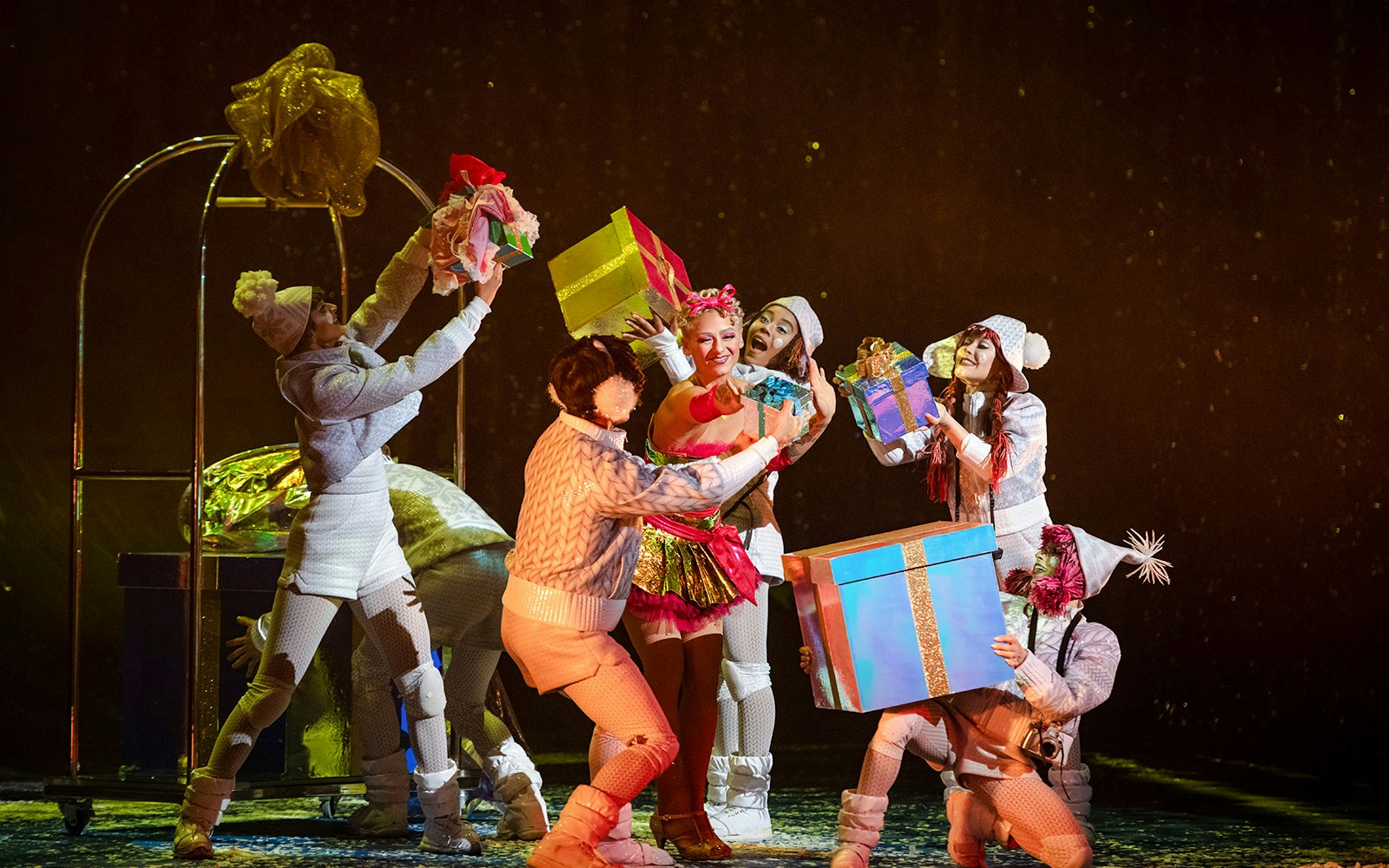 Performers exchanging gifts on stage during Cirque du Soleil's 'Twas The Night Before.