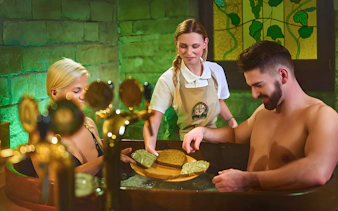 Couple enjoying a beer spa experience with unlimited beer in Spa Beerland.
