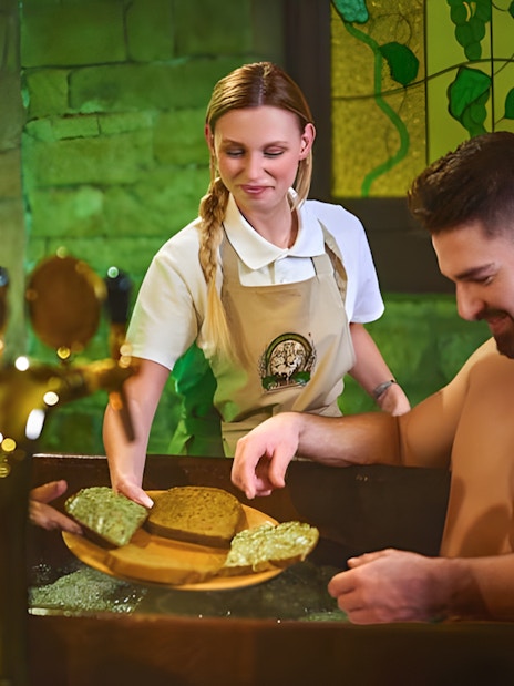 Couple enjoying a beer spa experience with unlimited beer in Spa Beerland.
