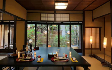 Kaiseki dinner table setup in Kyoto lifestyle museum with garden view.